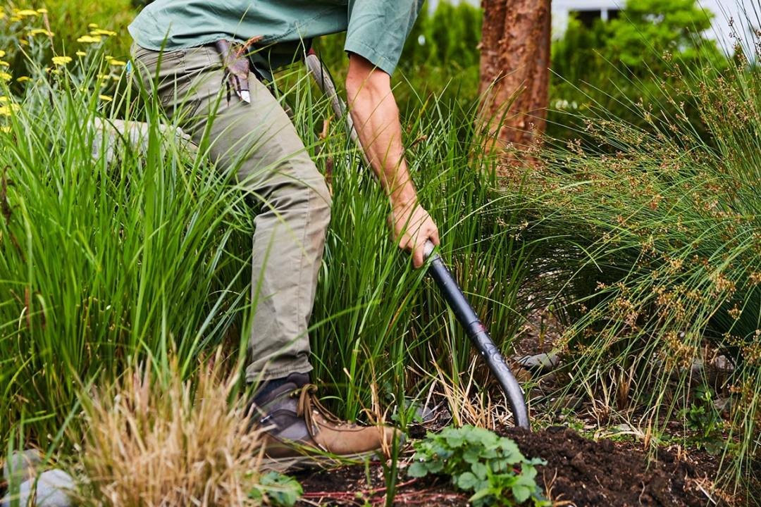 Planting Services from 7 Dees Garden Centers 7 Dees employee digging and planting in customer yard