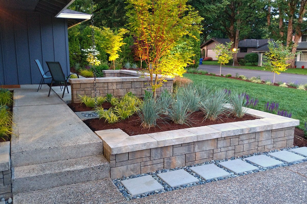 Front yard landscape ideas with hardscaping, stone walls, smooth pavers and plantings by Dennis' 7 Dees Landscaping