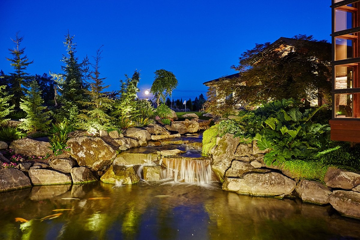 koi pond and waterfall at night in landscape