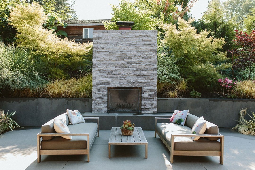 beautiful outdoor fireplace with seating by Dennis' 7 Dees