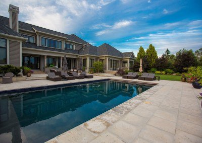 paver patio with large pool in summer