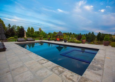 paver patio with large pool in summer