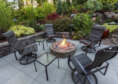 patio with fire pit and chairs by Dennis' 7 Dees