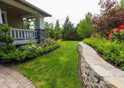 Residential Landscape Design with Stone Wall, Lawn, and Plants by Dennis' 7 Dees