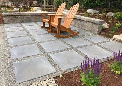 paver and gravel patio area with chairs