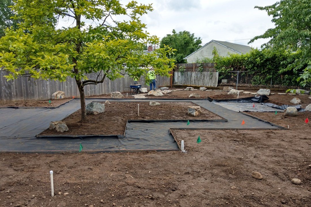 Landscape in progress with angled path and dirt with boulders - 7 Dees Landscaping