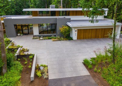 Custom poured concrete driveway with sharp modern lines and matching plantings - 7 Dees Landscaping