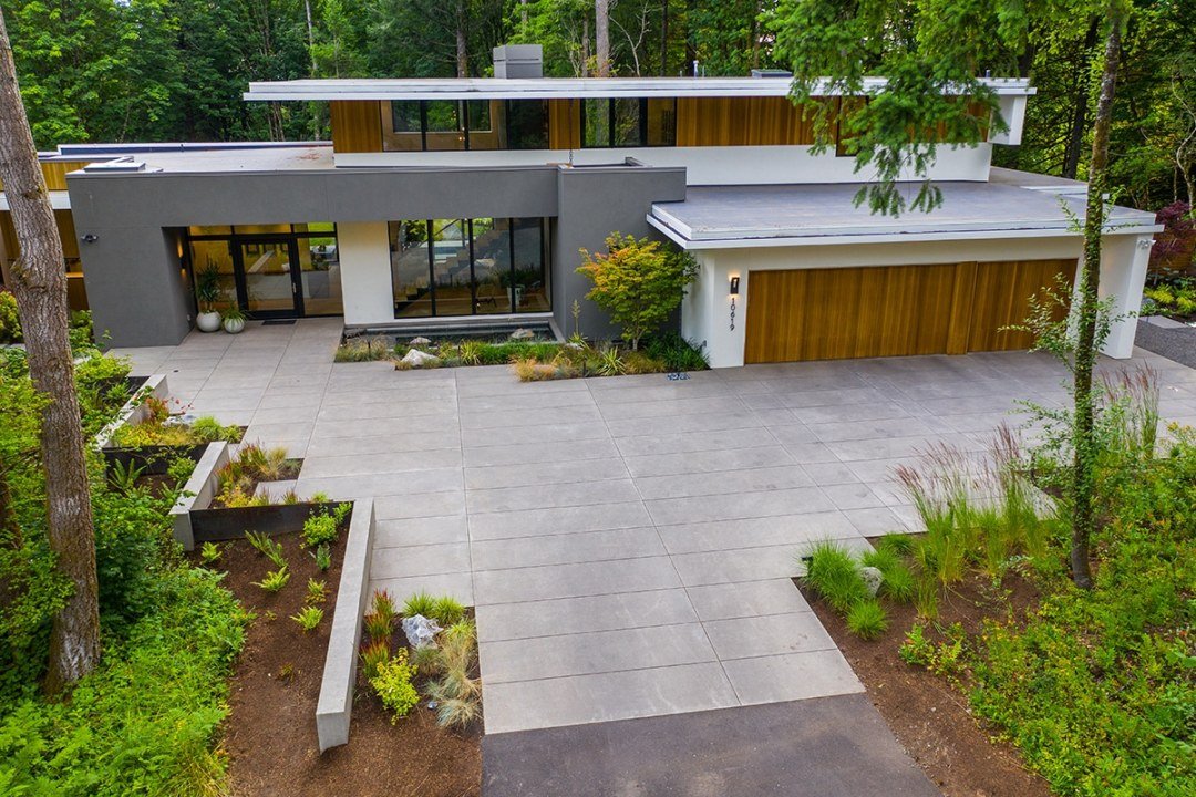Custom poured concrete driveway with sharp modern lines and matching plantings - 7 Dees Landscaping