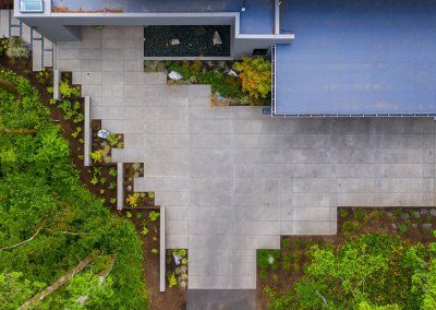 Modern backyard with pavers and asymmetrical layout and plantings seen from above