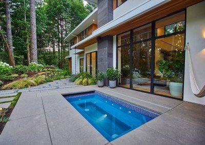 In-ground hot tub with containers and landscape design features by Dennis' 7 Dees