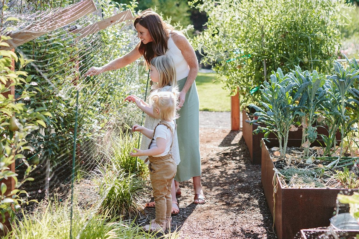 family in veggie garden with raised garden beds by Dennis' 7 Dees