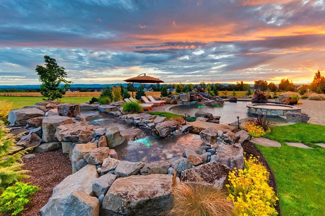 Natural waterfall spillway water feature in residential landscape by Dennis' 7 Dees