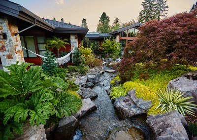 Natural stream water feature with boulders custom designed and built by Dennis' 7 Dees