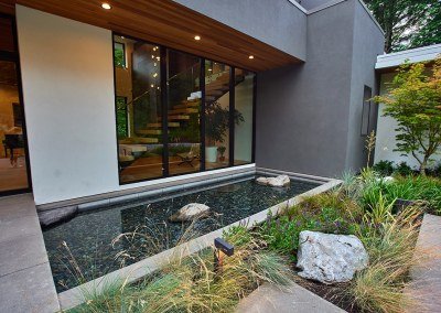 Serene modern reflecting pool water feature by Dennis' 7 Dees Landscaping