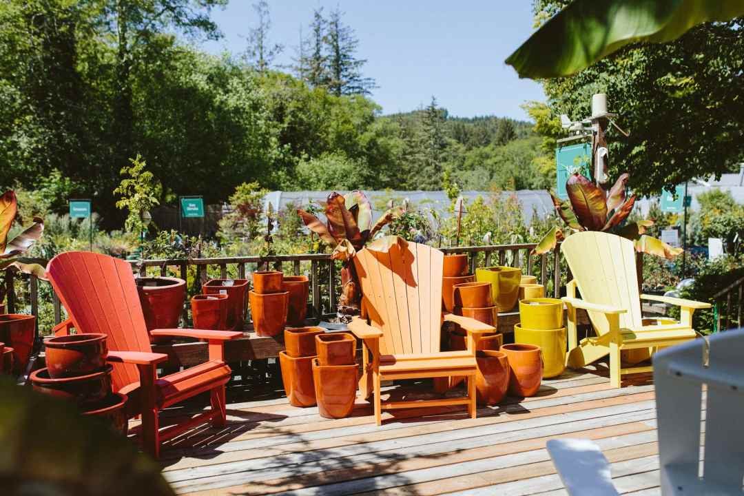 adirondack chairs in red, orange, and yellow displayed on a patio