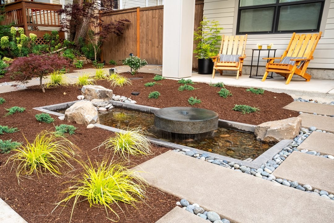 Custom water feature reflection pool with mill stone and modern plantings - 7 Dees Landscaping